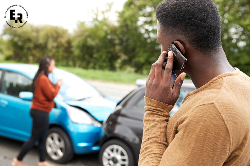 man talking on phone after a car accident