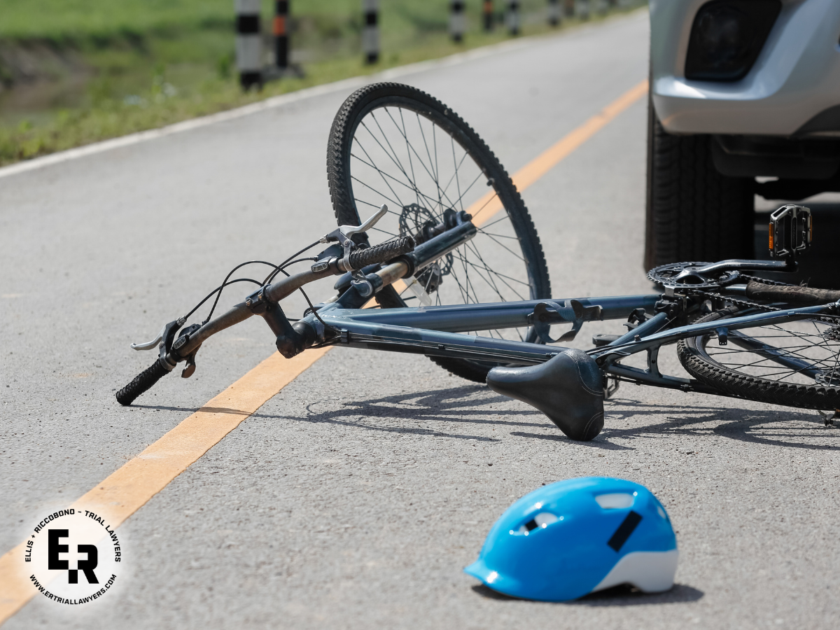 bicycle and helment laying on road after car crash